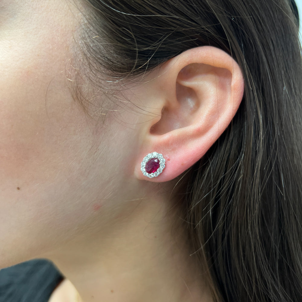 DFJ 18 Karat White Gold Oval Cut Rubies Stud Halo Earrings - 1.75 TWT