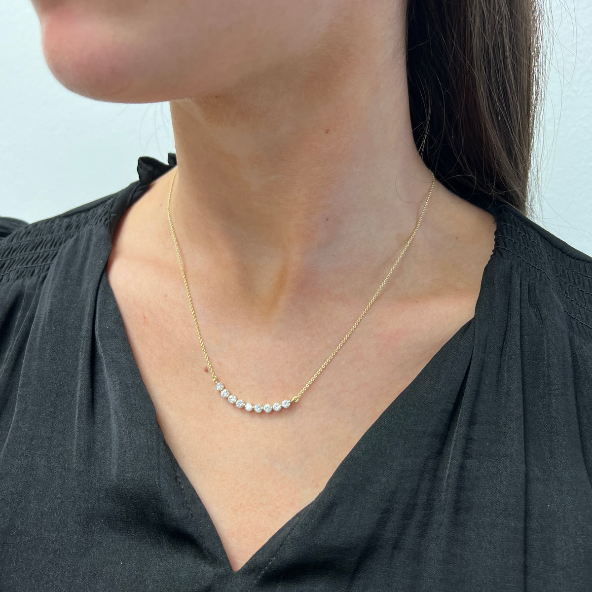 DFJ 14 Karat Yellow Gold Nine Diamond Curved Bar Necklace
